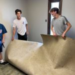 Hudson Corley, son of Lane Corley, (right) Louisiana Baptist church planting strategist and pastor of the Bridge Church, Madisonville, helps clear carpet from a mission site in Nashville as part of Youth on Mission.