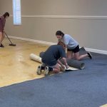 Karen Lewis (right), daughter of Louisiana Baptist Youth Ministry Strategist Brandon Lewis, removes carpet from a site during the Youth On Mission event.