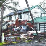 High winds toppled this pole and left a pile of debris on the yard of a home in southeast Louisiana. Baptist Message photo