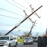 Automobiles navigate around fallen poles in southeast Louisiana. Baptist Message photo