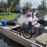 A Louisiana Department of Wildlife and Fisheries agent helped load a wheelchair-bound individual into a boat. LDWF photo