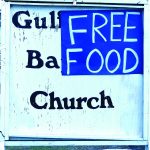 A sign advertised a free food giveaway by Gulf Coast Baptist Church in Golden Meadow. Baptist Message photo