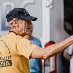 Arizona Baptist Disaster Relief team member Dave Turner gestured toward Bethel Baptist Church in Bourg as he instructed college students on what to expect during this mudout job. TAB Media photo