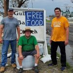 Louisiana State Rep. Gabe Firment, Gulf Coast Baptist (Golden Meadow) Pastor Shane Terrebonne and (First Baptist Pollock Pastor Brian Gunter stood near a sign advertising free food at Gulf Coast Baptist. Firment also is a member at FBC Pollock.