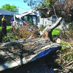 An Alabama Disaster Relief chainsaw team cut through a tree at a home in Belle Chasse. Patrick Dennis photo