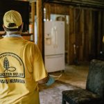 Kay Arnold, who is a member of Shawnee Heights Baptist Church in Topeka, Kansas, surveys the damage inside a LaCombe home. TAB Media photo