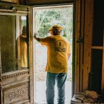 A volunteer from the Kansas-Nebraska Convention of Southern Baptists stood in the doorway of a LaCombe home that was flooded during Hurricane Ida. TAB Media