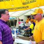 Steven Kelly, pastor of Bayou Vista Baptist Church in Morgan City, talks with an Oklahoma Baptist Disaster Relief team member. Kelly also is director of missions for Gulf Coast Baptist Association. Brian Blackwell photo