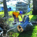 South Carolina Baptist Disaster Relief team members cut through a fallen tree in Belle Chasse. Patrick Dennis photo