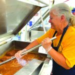 An Oklahoma Baptist Disaster Relief team member prepares food at Bayou Vista Baptist Church in Morgan City. Brian Blackwell photo