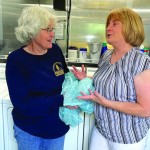 Oklahoma Baptist Disaster Relief team member Linda Long and Bayou Vista Baptist Church member Barbara Guillot visit inside the laundry trailer at Bayou Vista Baptist. Brian Blackwell photo