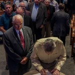 Deacons of First Baptist Church, Pineville, sign documents after a vote was held to merge with First Baptist Church, Lecompte.
