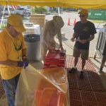 Rolling Hills feeding unit team members unload supplies under a tent at First Baptist Church, Naples, Florida.
