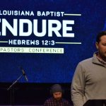 Pastors Conference President James Doughty prays during the opening session. Doughty is pastor of First Baptist Church, Monroe.
