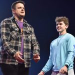A student assists illusionist Jared Hall with a magic trick.