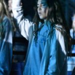 A student participates in a time of worship at YEC.