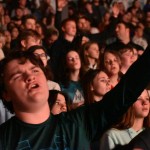 A student participates in a time of worship at YEC.