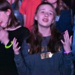 A student participates in a time of worship at YEC.