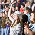 A student participates in a time of worship at YEC.