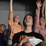 Students participate in a time of worship at YEC.