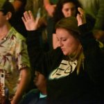A student participates in a time of worship at YEC.