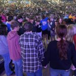 Students pray for their lost friends and other needs during the closing session of YEC.