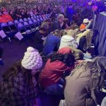 Students pray for their lost friends and other needs during the closing session of YEC.