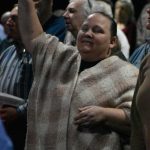 A woman sings during a time of praise and worship at the Big Creek Baptist Association Revival.