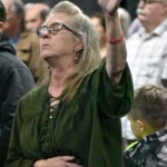 A woman lifted her hands in praise at the Big Creek Baptist Association Revival.