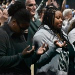 Women lifted their hands in prayer during the Big Creek Baptist Association Revival.