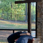Two campers kneeled before the cross and said a prayer during the three-day Champions Camp at Tall Timbers. Submitted photo