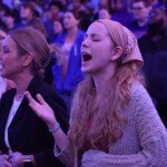 A student raised her hands toward heaven during a praise song at an LCU spring revival service.
