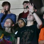 Students lifted their hands in praise.