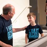 A young boy stirred the baptistery waters March 30, 2025, at First Baptist Church, Denham Springs. He was among 55 people baptized that day.