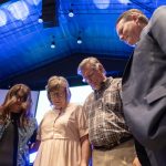 Shawna Davis, IMB missionary to Sub-Saharan Africa, left, prayed with newly appointed missionaries, Sean and Pam Keith, center, Philip Robertson, right, senior pastor of their sending church, Philadelphia Baptist Church, Deville, Louisiana, and other family and friends. The Keiths are two of 54 newly appointed IMB missionaries participating in the IMB Sending Celebration, Sept. 24, at Ironbridge Baptist Church in Chester, Virginia. IMB Photo