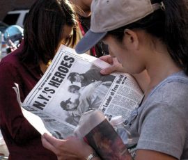 While waiting in line for press credentials, Minnie Roh, a producer for the NBC television news magazine program ‘Dateline,’ keeps up with the latest events surrounding the Sept. 11, 2001, terrorist attack of the World Trade Center. Photo by Jim Veneman